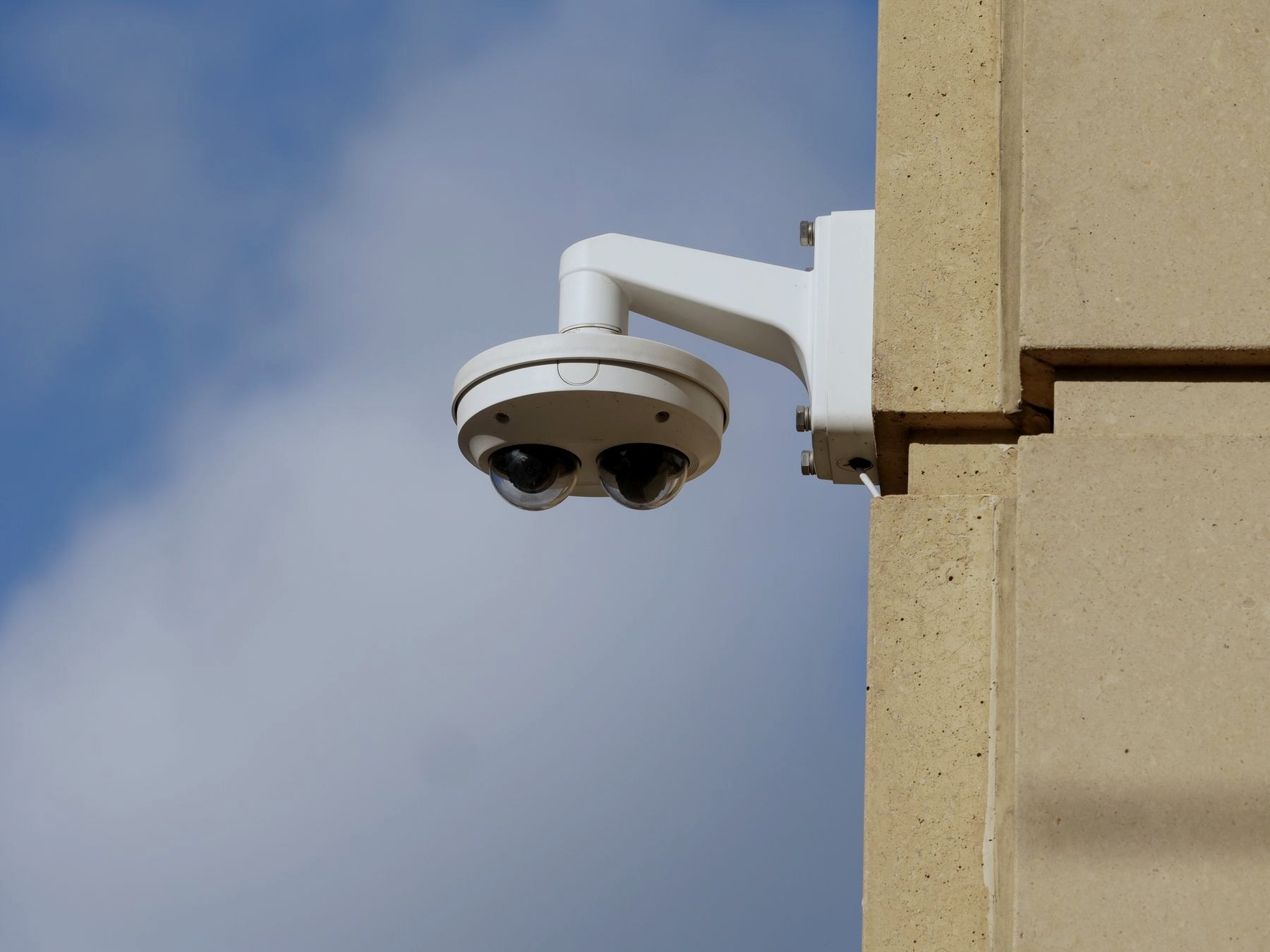 Building surveillance camera on an exterior wall