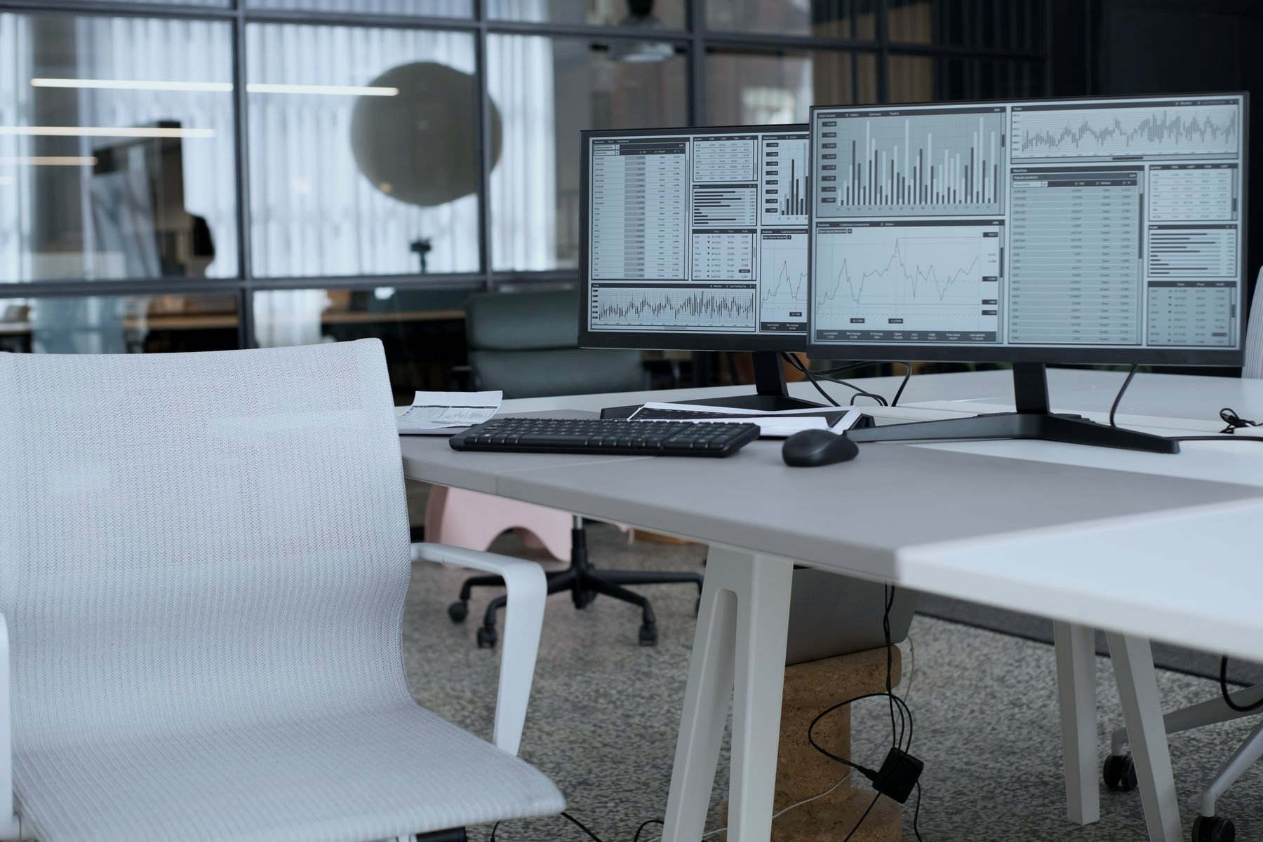 Operations desk with dual monitors showing live dashboards